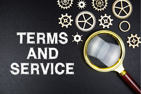 Term Of Service text message with magnifying glass on black background
