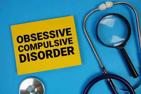 Obsessive-Compulsive Disorder (OCD) text with Stethoscope and magnifying glass on blue backgroundの写真素材