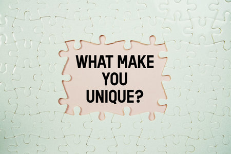 Jigsaw puzzle with a missing piece with What Make You Unique? on pink background