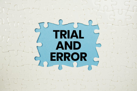 Jigsaw puzzle with a missing piece with Trial And Error on yellow background