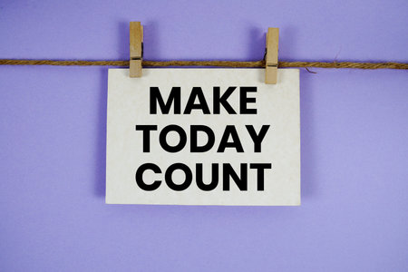 Make Today Count text written on paper card with rope and wooden clip hanging