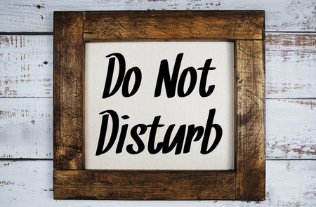 Wooden Frame with text Do not disturb on wooden background