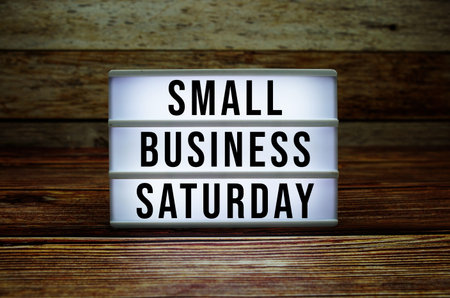 Lightbox with text Small Business Saturday on wooden background