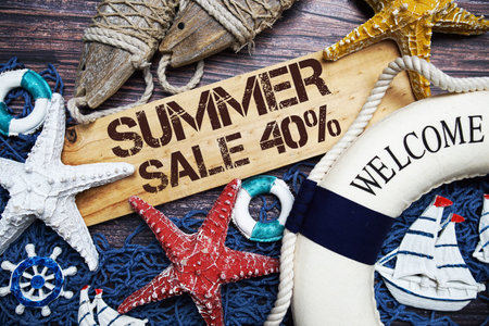 Summer Sale 40% off text on wooden sign decorated with marine nautical on a wooden background