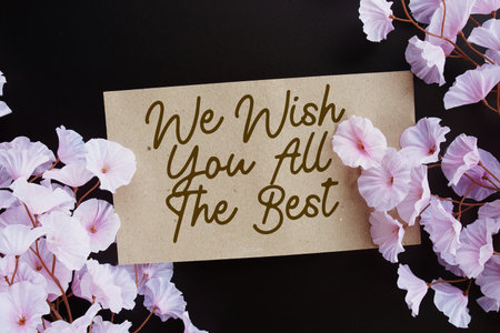 We Wish You All The Best text with flower decoration on black background