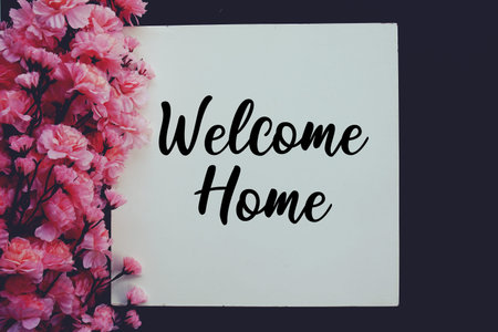 Welcome Home text with flower decoration on black background