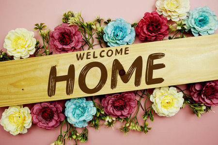 Welcome Home text with flowers decoration on pink background