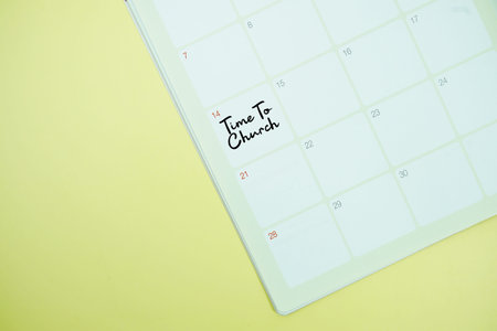 Time to Church message written on calendar date flat lay on yellow background