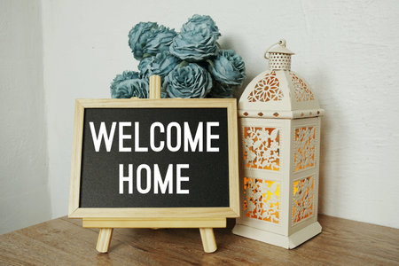 Welcome Home text on blackboard easel stand with home element decoration