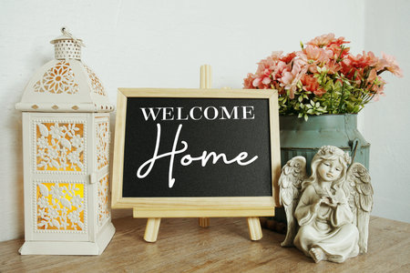 Welcome Home text on blackboard easel stand with home element decoration