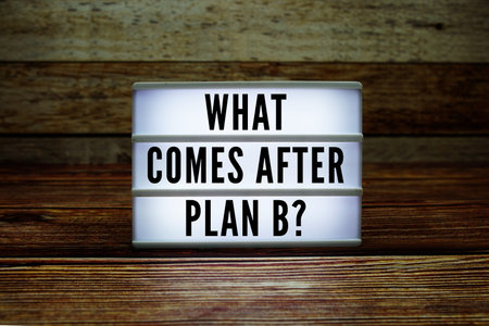 Lightbox with text What Comes After Plan B? on wooden background
