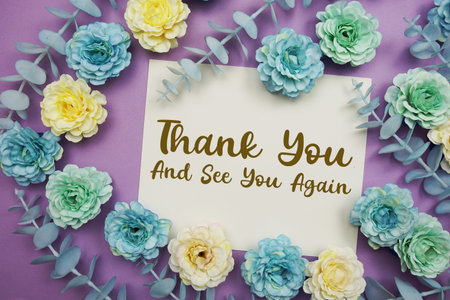 Thank You text written on paper card with flowers decoration