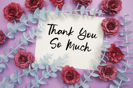 Thank You text written on paper card with flowers decoration