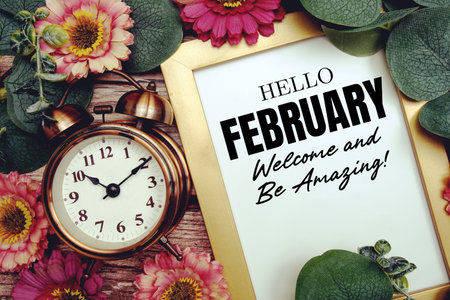 Welcome 
February text with flower decoration on wooden background
