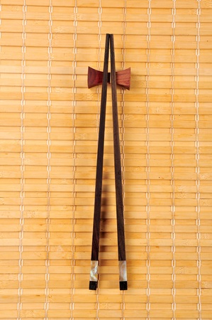Two chopsticks on sushi matの写真素材