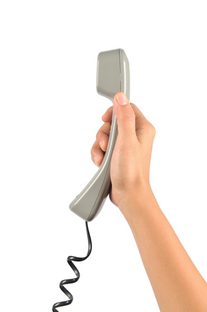 Telephone receiver in hand, isolated on white backgroundの写真素材