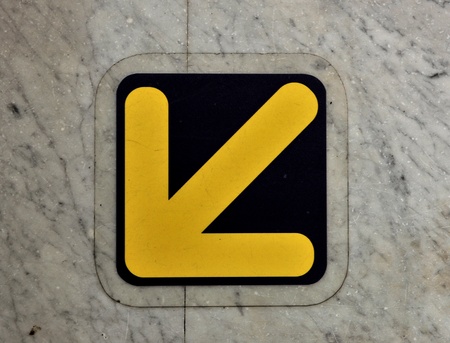 A forwarded yellow arrow on the groundの写真素材