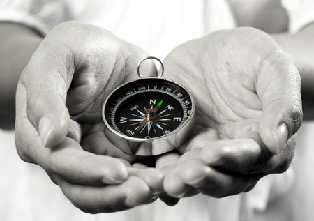 Hand holding the black compass