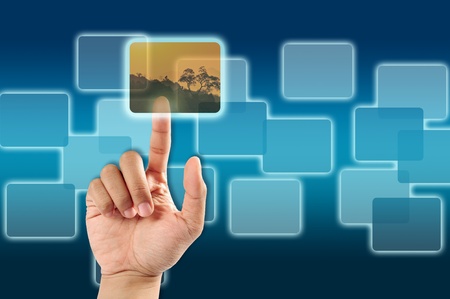 hand pushing a button on a touch picture screen interfaceの写真素材