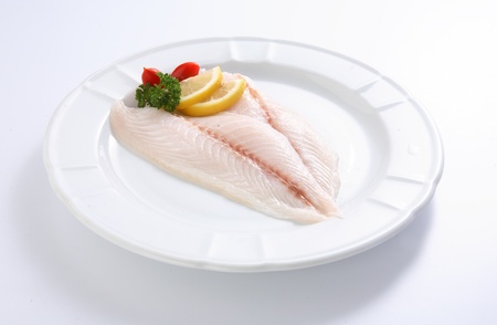 Fresh fish close up on a white plateの写真素材