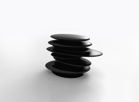 Isolated black massage spa stones on white surface の写真素材
