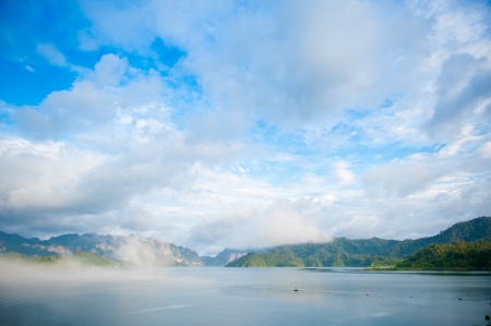 colorful summer morning with golden light and fog between hills の写真素材
