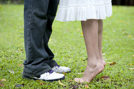 Closeup of male and female legs during a dateの写真素材