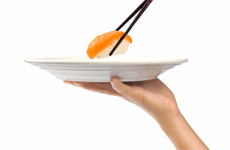 hand with chopstick holding a sushi foodの写真素材