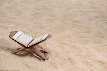 Ramadan Kareem with the Holy Quran. The Koran on the beach is cool and peaceful.