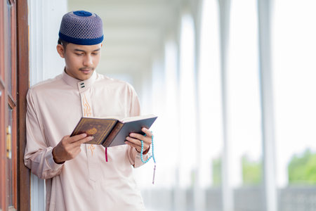 muslim man reading quran and praying inside the mosque, the muslim conceptの写真素材