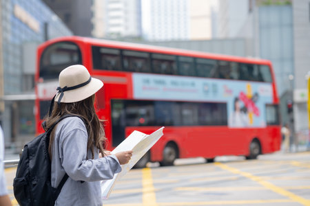 Asian tourist, cute woman with long hair are traveling in Hong Kong along with map and her camera with fun on her holiday,traveler relaxing and enjoying at Hong Kong.の写真素材