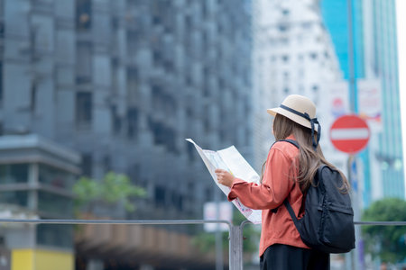 Asian tourist, cute woman with long hair are traveling in Hong Kong along with map and her camera with fun on her holiday,traveler relaxing and enjoying at  Hong Kong.の写真素材