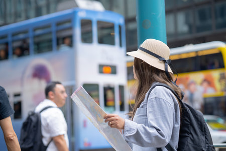 Asian tourist, cute woman with long hair are traveling in Hong Kong along with map and her camera with fun on her holiday,traveler relaxing and enjoying at  Hong Kong.の写真素材