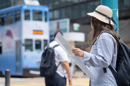 Asian tourist, cute woman with long hair are traveling in Hong Kong along with map and her camera with fun on her holiday,traveler relaxing and enjoying at  Hong Kong.の写真素材
