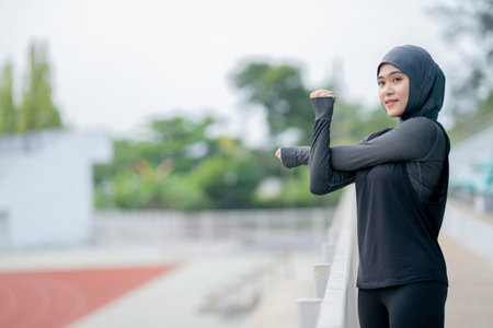 Portrait of muslim woman in sportswear stretching before joggingの写真素材
