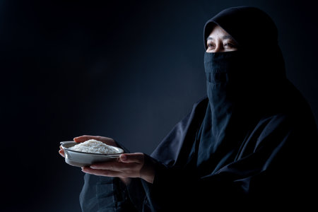 Hands holding a money bag for zakat, Islamic zakat concept. Muslims help the poor and needy. Conceptual shoot for property, income, and fitrah zakat.の写真素材