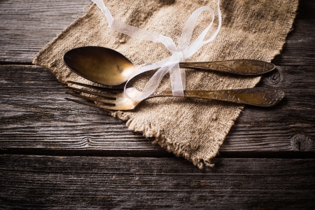 Old fork and spoon on wooden backgroundの写真素材