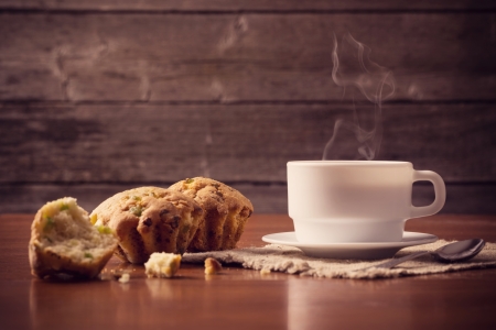Cup of hot coffee with cake on wooden backgroundの写真素材