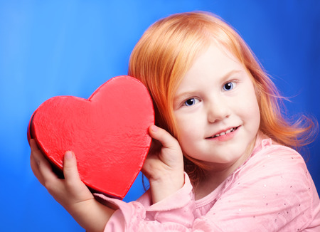 smile girl with red box on blue backgroundの写真素材