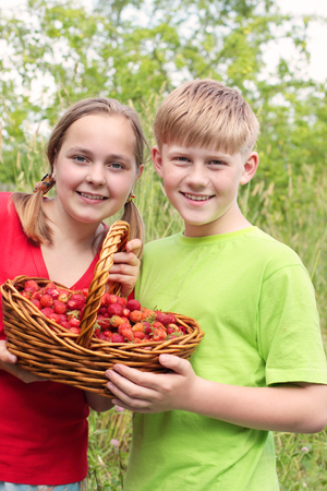 children with berries outdoorの写真素材