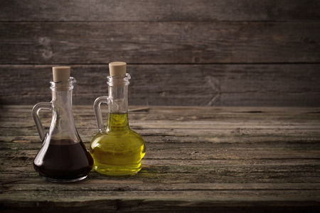 olive oil and balsamic vinegar on a wooden backgroundの写真素材