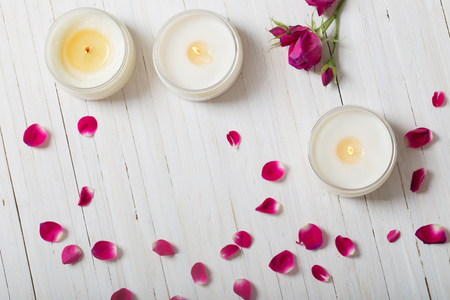 roses with candles on a wooden backgroundの写真素材