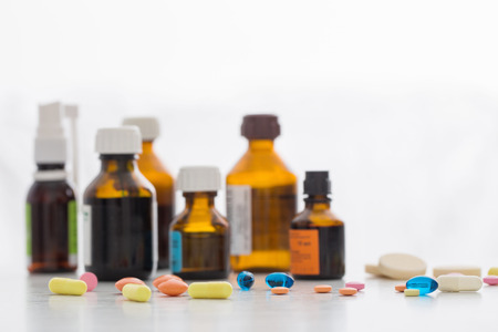 Composition of medicine bottles and pills  on white backgroundの写真素材