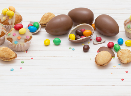 Chocolate Easter Eggs and Cupcake Over Wooden Backgroundの写真素材