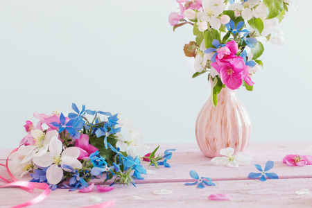 Beautiful ripe apples and branches in vase on whiteの写真素材