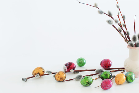 Easter eggs and willow branches on a white backgroundの写真素材