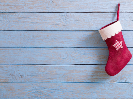 Christmas stockingwith gifts on  wooden wallの写真素材