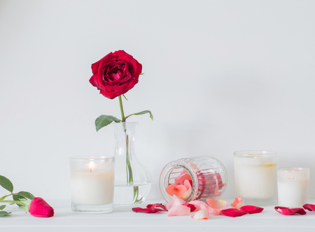 roses in a vase and candles on white backgroundの写真素材