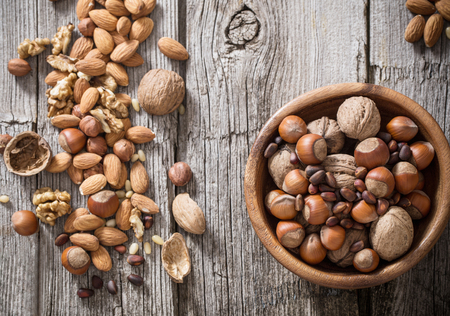 Mixed nuts on old wooden backgroundの写真素材