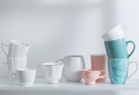 Clean dishes on white wooden shelfの写真素材